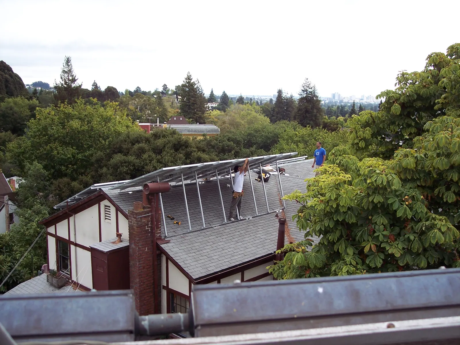 Technicians working on a solar PV array on a roof