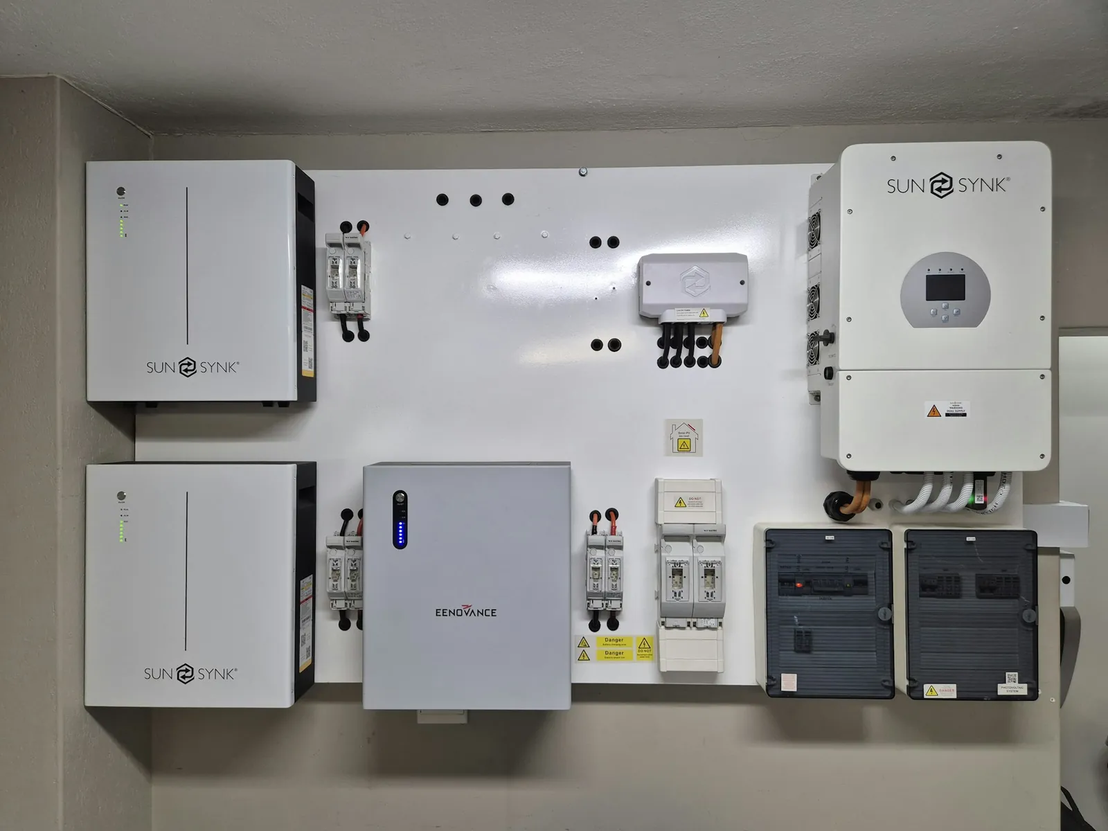 A wall-mounted home battery, inverter and distribution board installed together