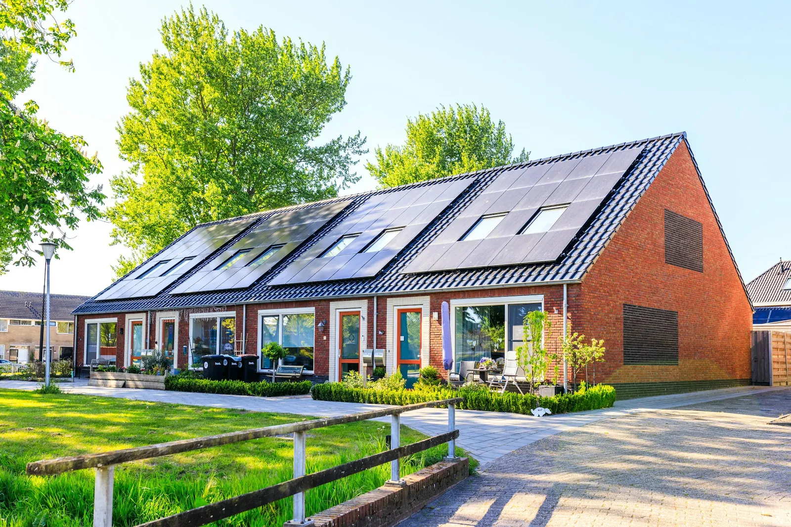 A house with a large array of solar panels on its roof